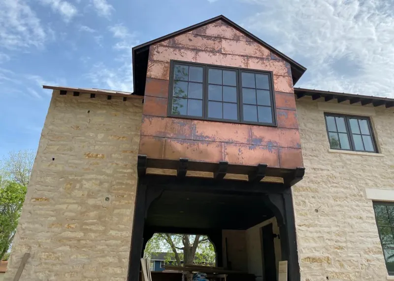 Copper metal panel facade on a stone building for Skylight Installation in Glen Cove